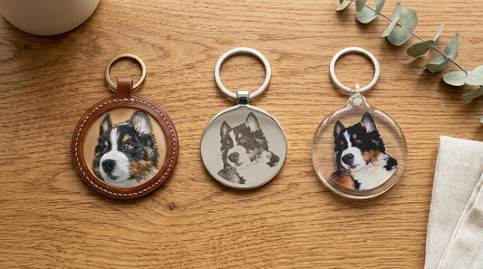 Three custom pet keychains in leather, metal, and acrylic displayed side by side — leather vs acrylic vs metal pet keychain comparison